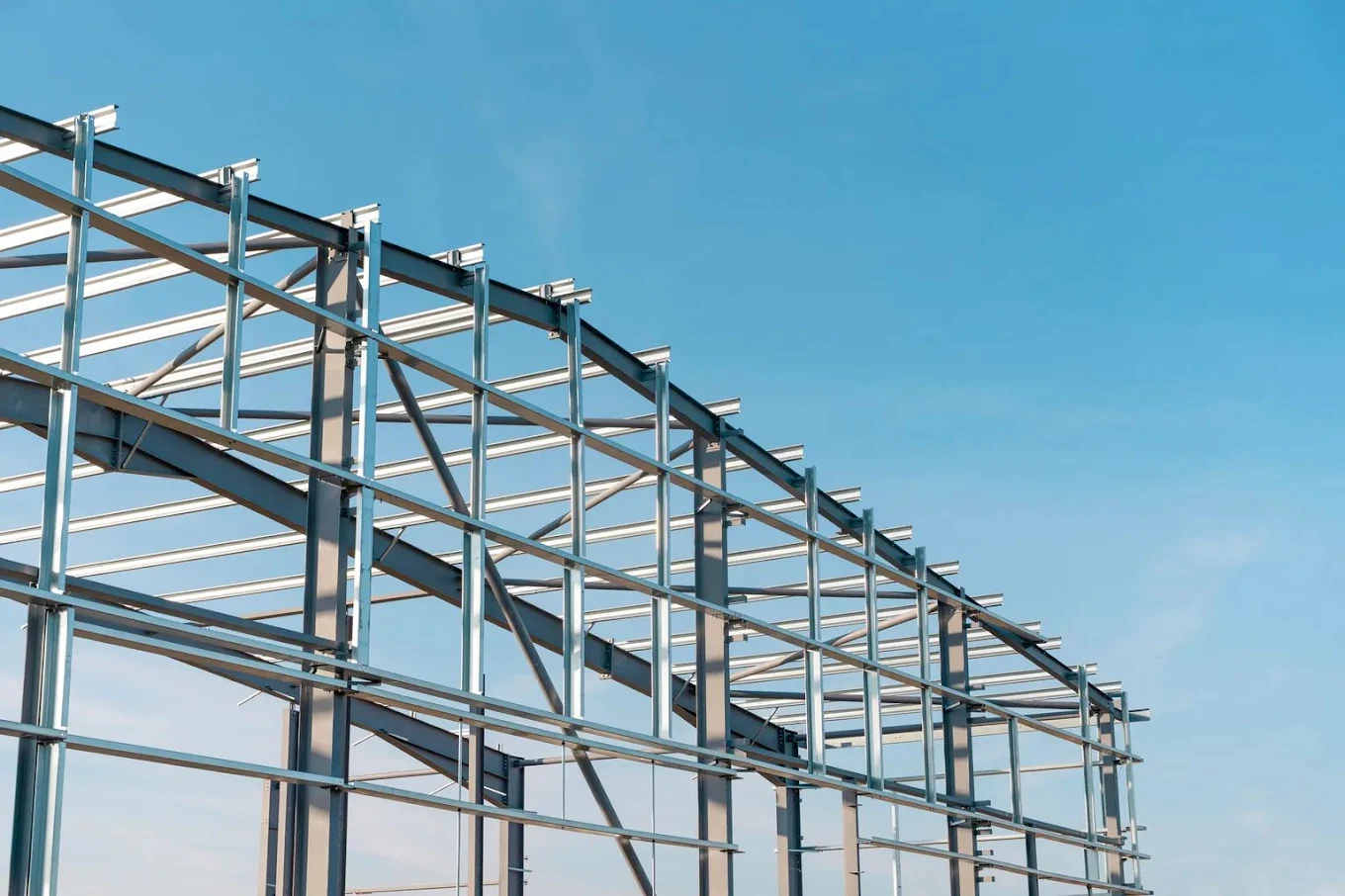 Steel building frame against a clear sky
